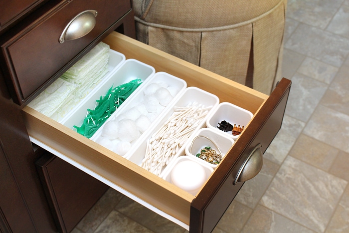 Toiletry items in the plastic organizer in the drawer.