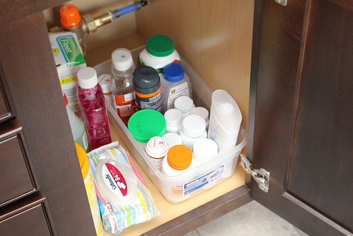 Cleaning supplies under the sink.