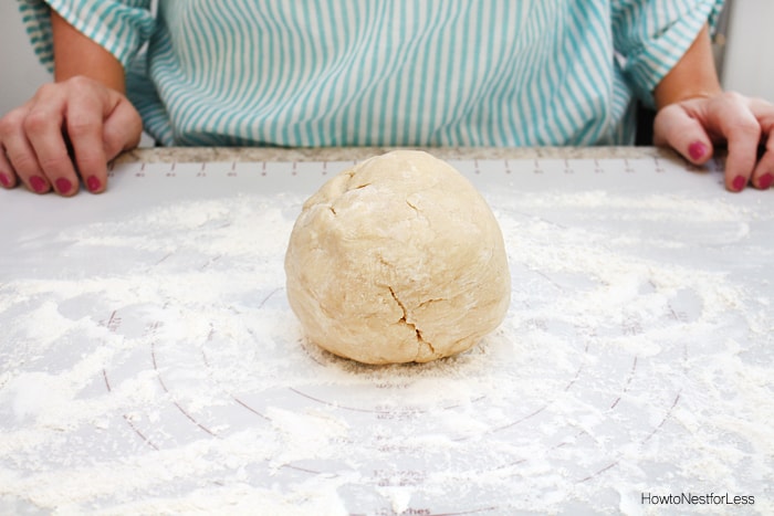 The dough in a ball on the floured counter.