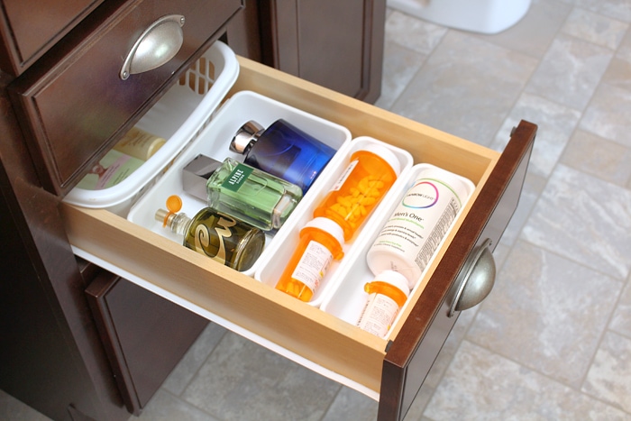 The middle drawer with cologne and medication.