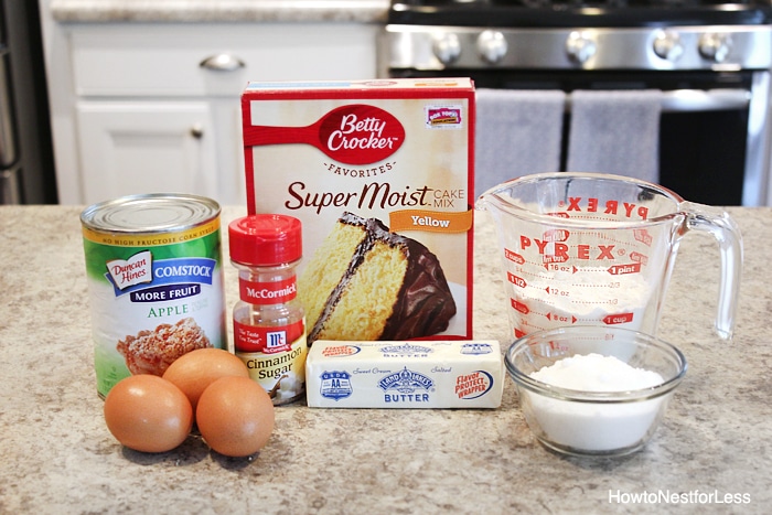Cake mix, eggs, canned apples, butter on counter.