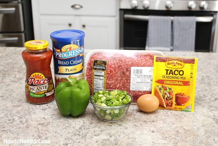 Ground beef, green pepper, taco seasoning, an egg, salsa and breadcrumbs on the counter.