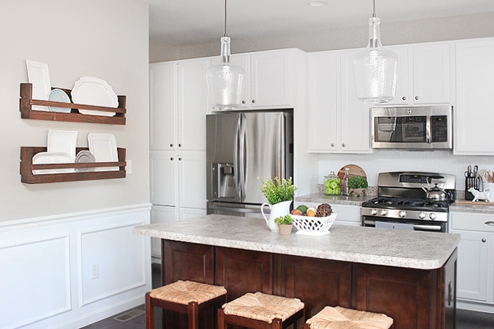 Clear glass pendant lights above the kitchen island.