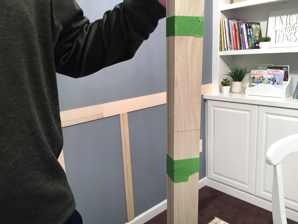 Wooden boards taped together with a man holding them.