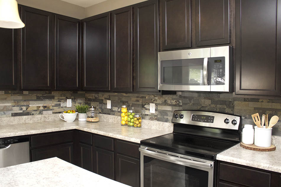 Stove, microwave, and white counters in kitchen.