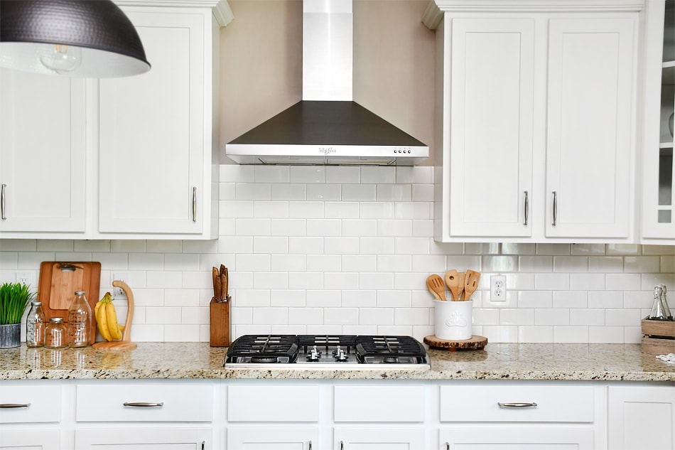 Wooden spoons, wooden cutting board and a wooden knife block on the counter.