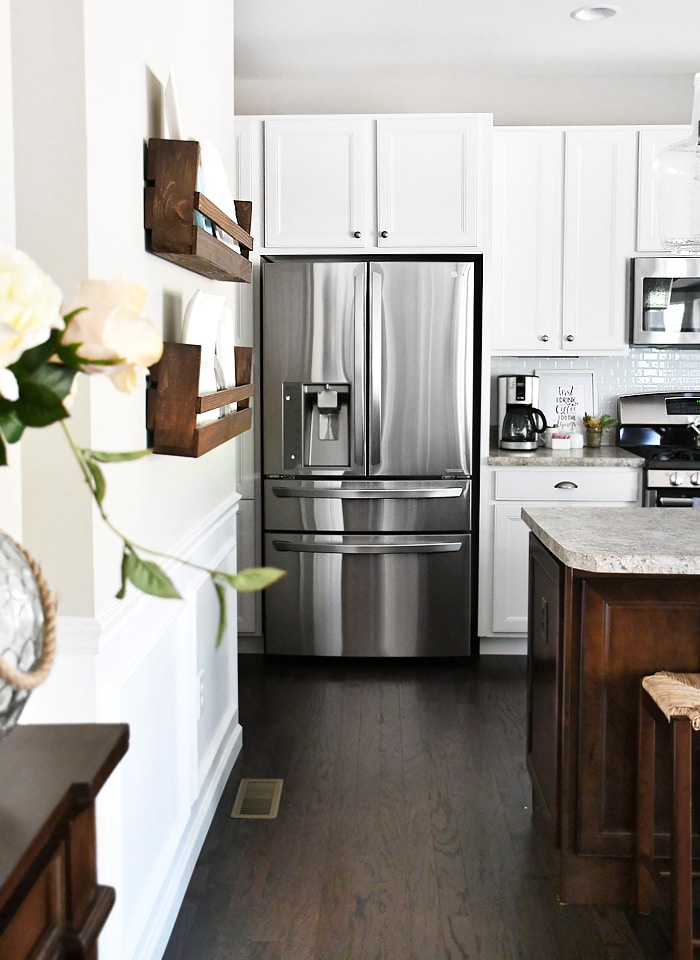 White Kitchen Cabinets With Dark Wood Island to the left of the fridge we have the doors to our laundry room and powder room and our super pantry cabinet just to the left of the refrigerator