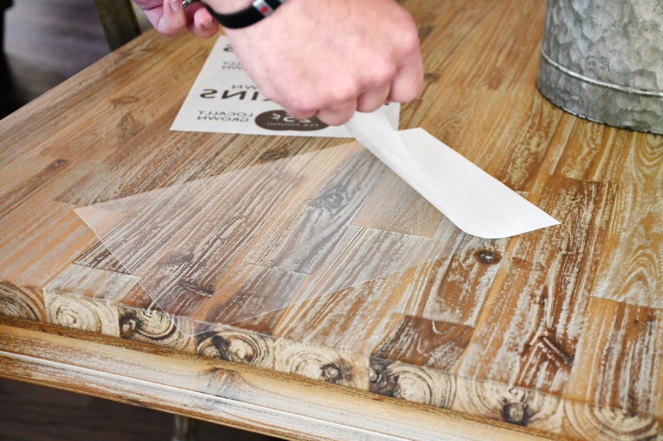 Pumpkin adhesive paper peeling the backing.