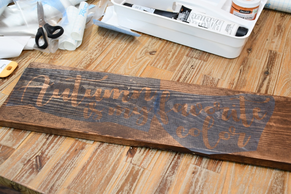 Writing the quote on the stained wood.