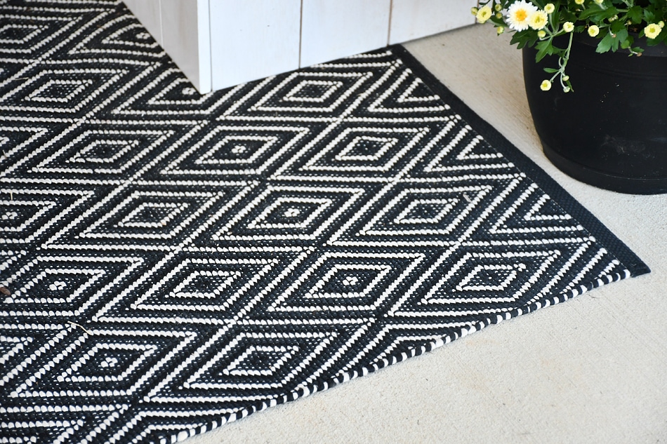 Black and white rug on front porch.