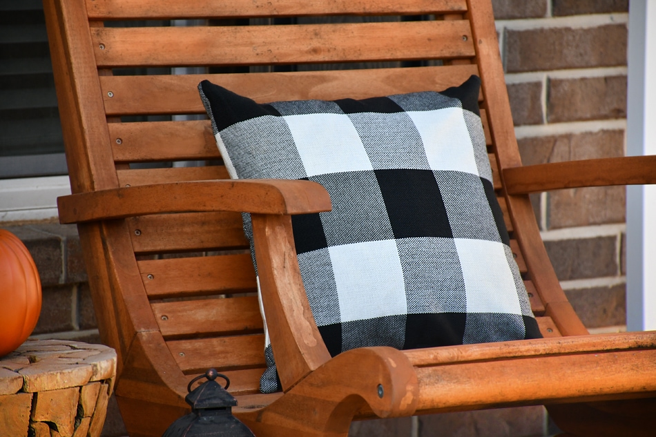 Up close picture of the black and white pillow on outdoor chair.