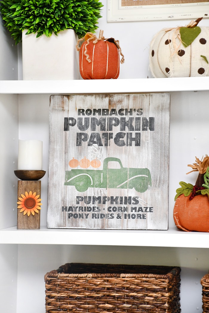 Pumpkin farm sign displayed on shelf.