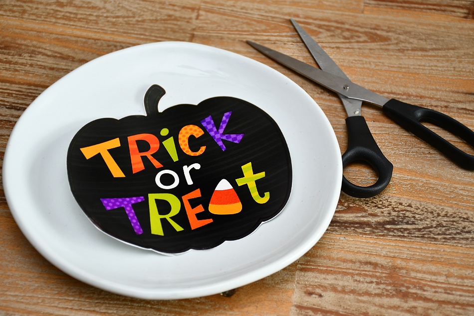 Cutting out the black trick or treat sticker.