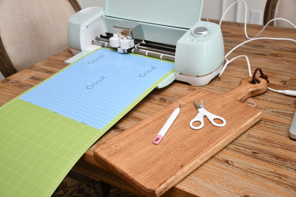 A cutting and stenciling machine with scissors beside it.