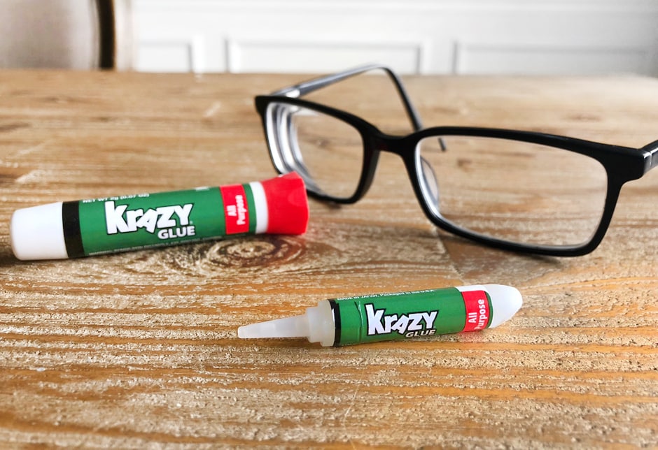 Eyeglasses on the counter with Krazy Glue beside them.