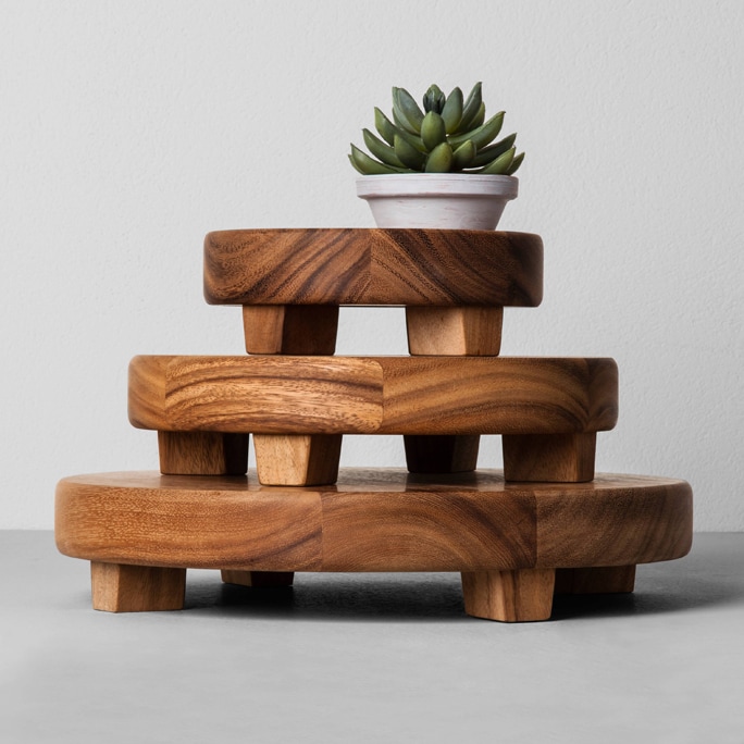 Wooden home footed trays with a plant on top.