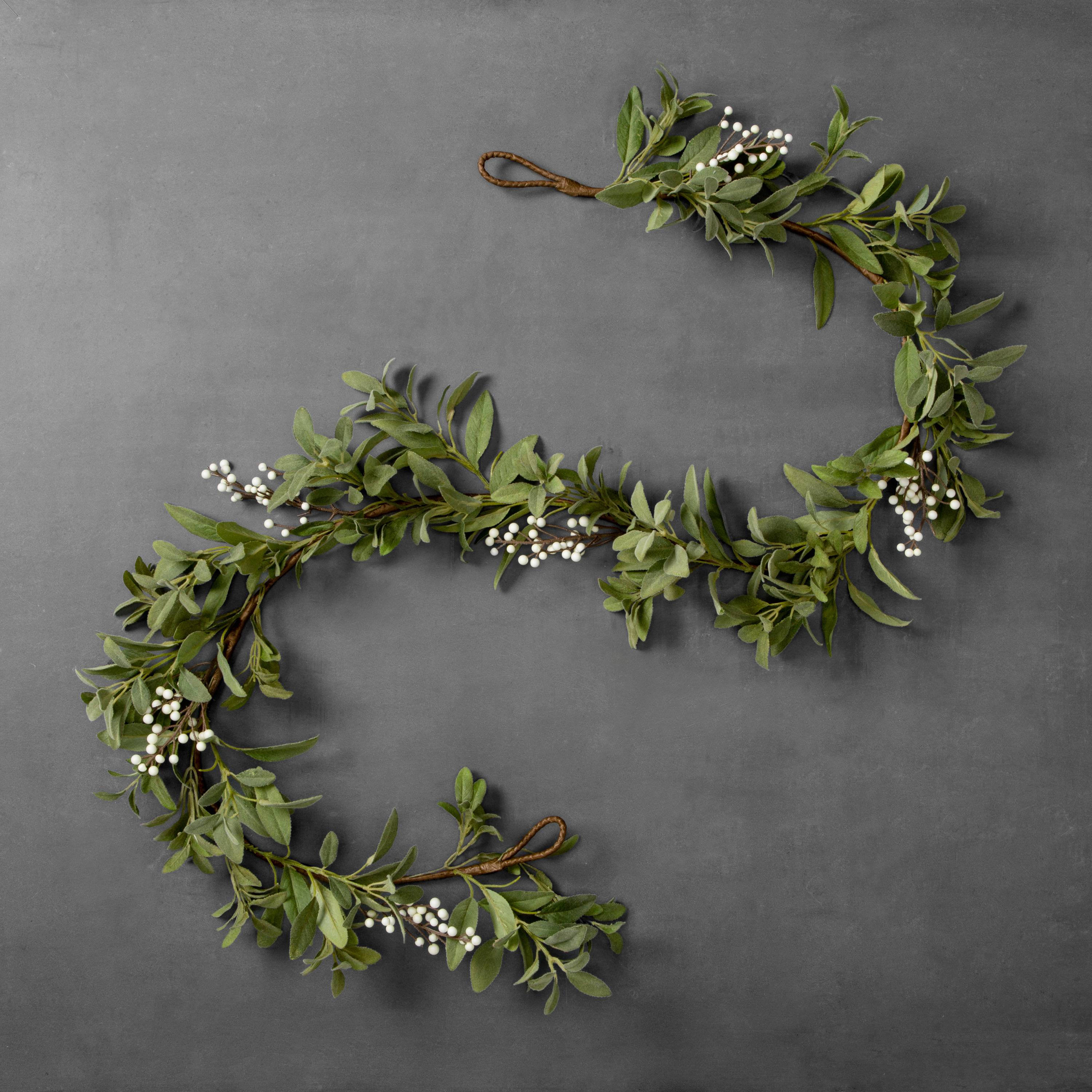 A white berry garland on the table.