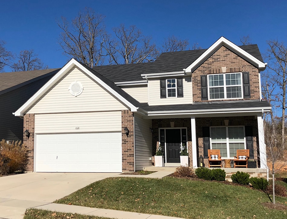 Full picture of multi level house with attached garage.