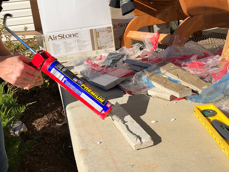 Airstone faux brick piece on workbench with  glue on the back of it.