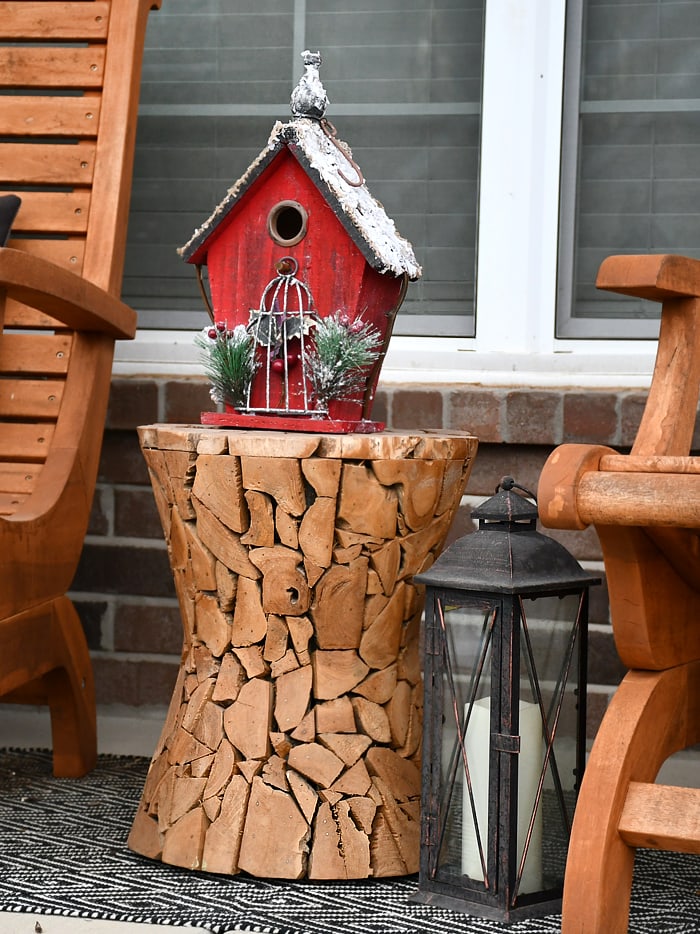 A dark red, flocked roofed birdhouse.