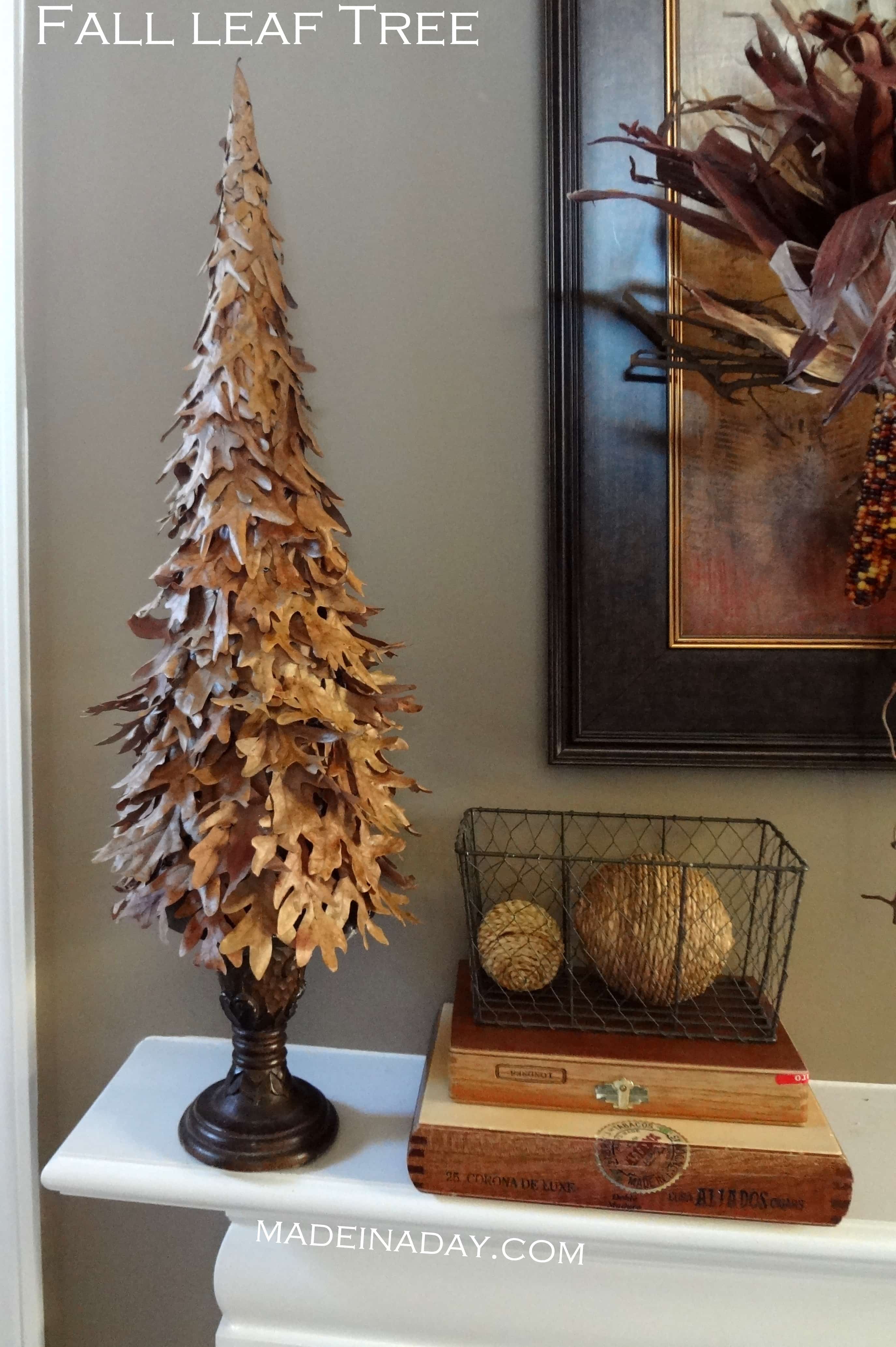 A mini tree made of leaves on the mantel.
