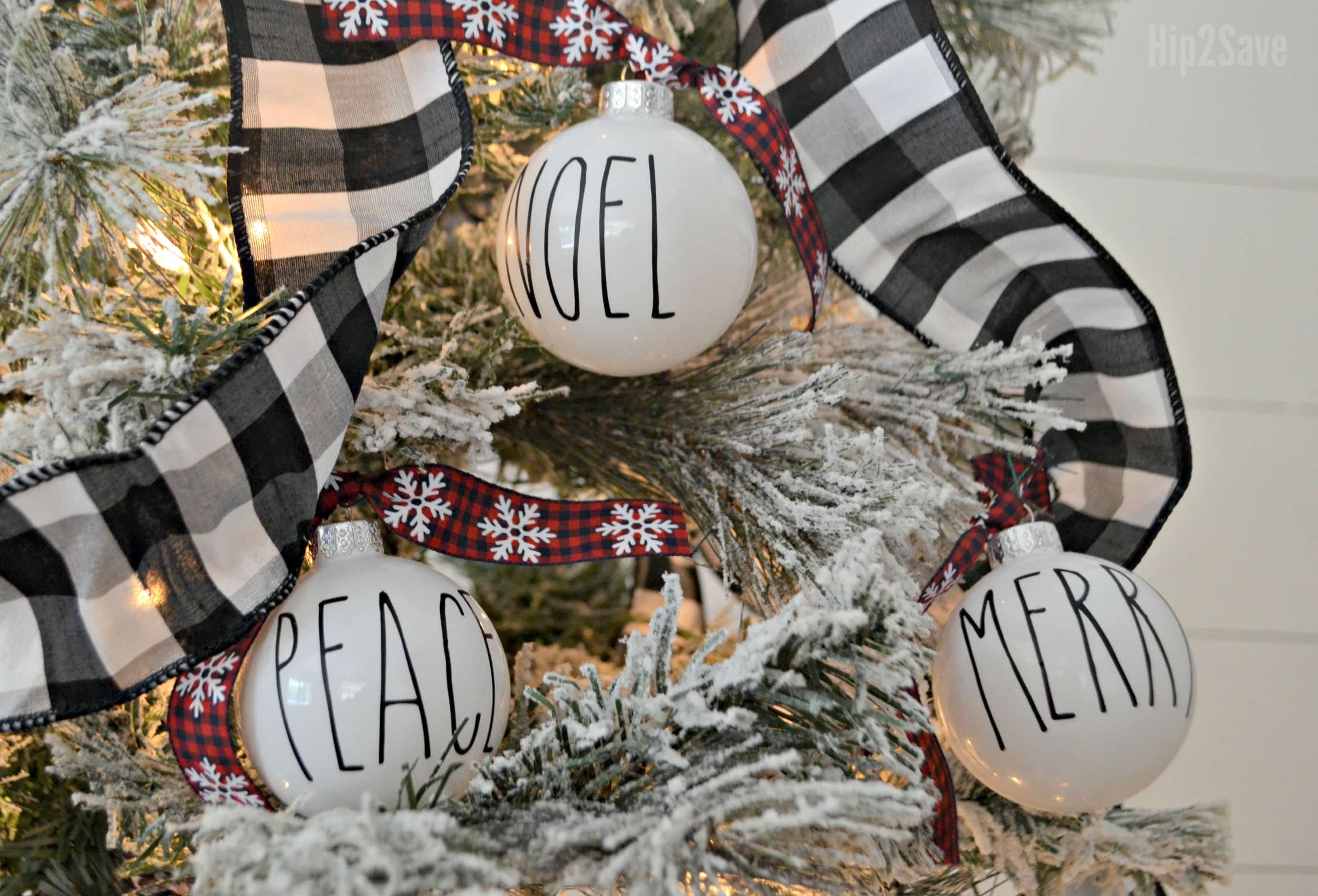 White ornaments with Noel, Peace, and Merry written on them in black sharpie.