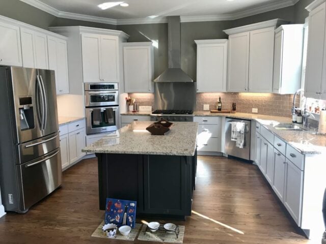 SW Iron Ore kitchen island with white upper and lower cabinets