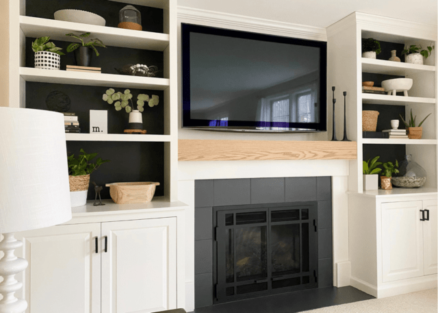 SW Iron Ore painted fireplace with white built ins and wood mantle