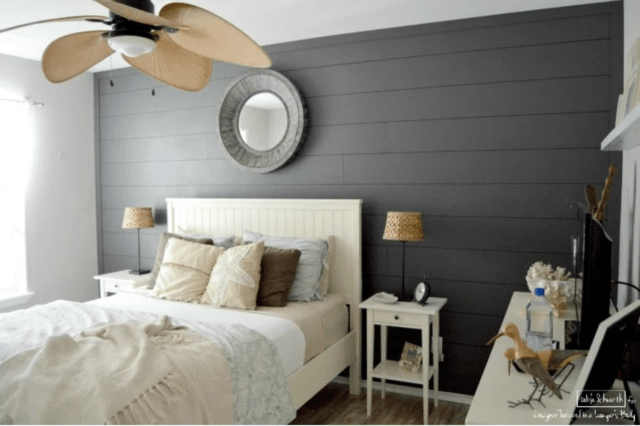 Dark gray shiplap accent wall with light bed and light nightstand