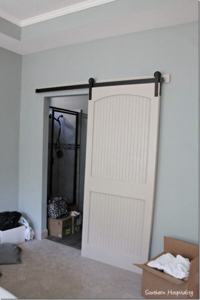 white barn door and wall painted Sherwin Williams Oyster bay