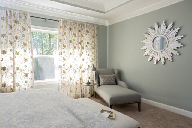bedroom with gray chaise lounge in the corner painted Sherwin Williams Oyster Bay