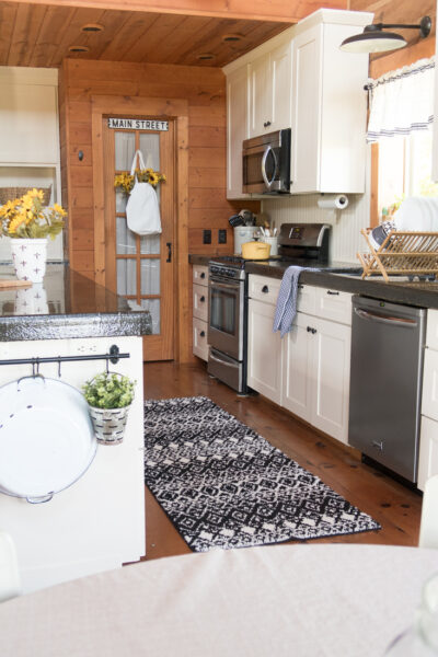 kitchen with white cabinets and sunflower decorations