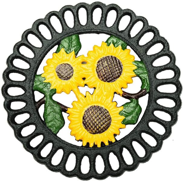 cast iron trivet with three sunflowers in the middle